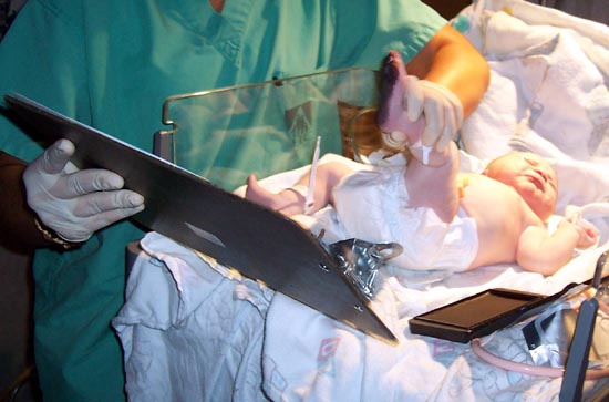 The nurse takes Audrey's footprint for the birth certificate
