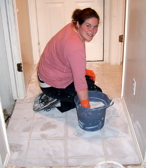 Tile project - Sarah wipes up grout downstairs