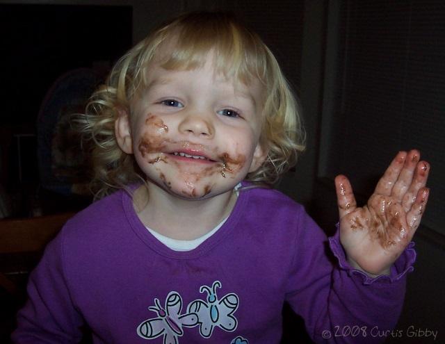 Messy Audrey eating chocolate cake batter