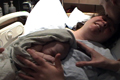 View - Labor and Delivery - Curtis kisses Sarah on the forehead while Nathan rests