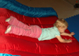 View - Trip to Wisconsin - Audrey sliding on the bouncy toy