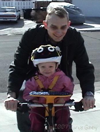 Audrey riding a bike with Curtis
