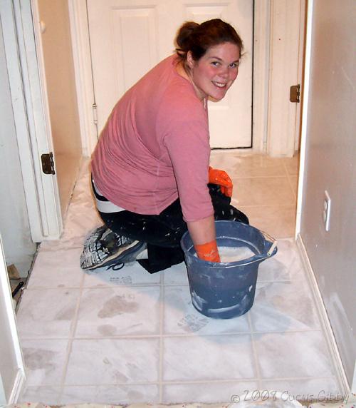 Tile project - Sarah wipes up grout downstairs