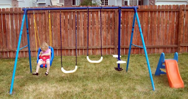 Audrey playing on our new swing set