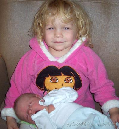 Audrey holds her new cousin Laura