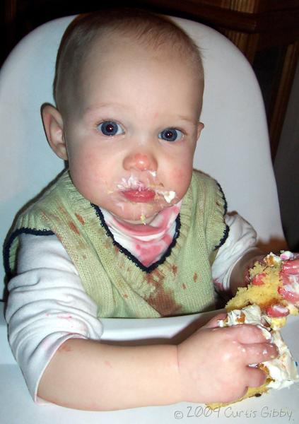 Messy Nathan eating his 1-year-old birthday cake