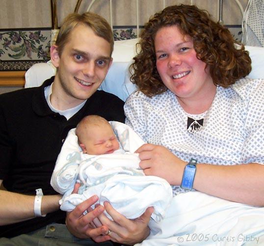 Curtis and Sarah and Audrey pose together as a happy family
