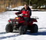 View - Curtis riding a 4-wheeler in the snow