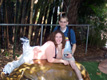 Curtis and Sarah sit on a hippo statue at the San Diego Zoo